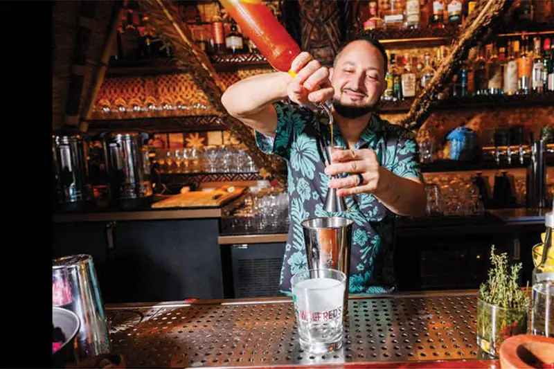 Wilfred's Lounge bartender making a cocktail